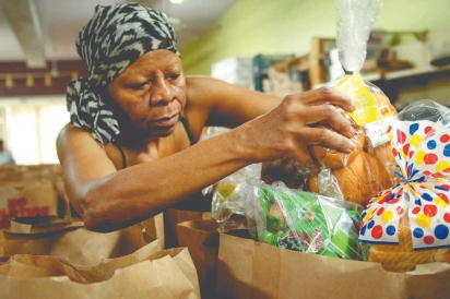 Charolette Tidwell packs bread for donation