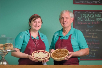 Sarah and Jerry Leding, holding a cherry pie and Dutch apple pie with salted carmel