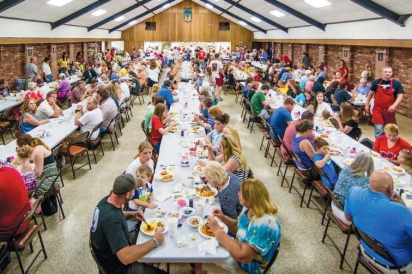 long table where people sit to eat at the Tonitown Grape Festival