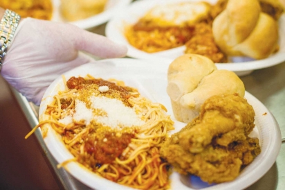 plate of spaghetti, fried chicken leg and roll